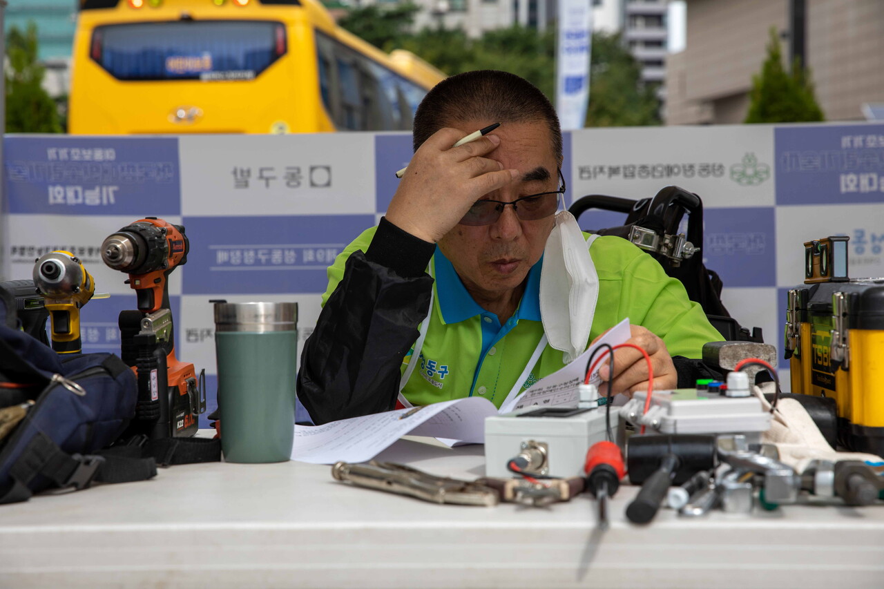 서울 중랑구에서 온 참가자 양일용(64) 씨가 필기시험에 집중하고 있다. 참가자들은 이동보조기기의 구성과 구동 상태, 모터의 정격전압, 기기의 오류신호 등에 관한 질문에 답했다. 박시몬 기자